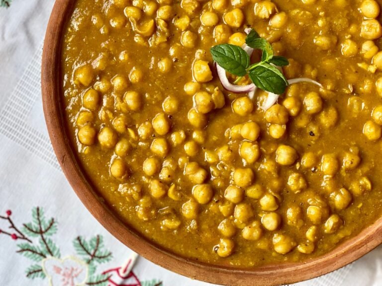 Chana masala chickpea curry garnished with fresh herbs