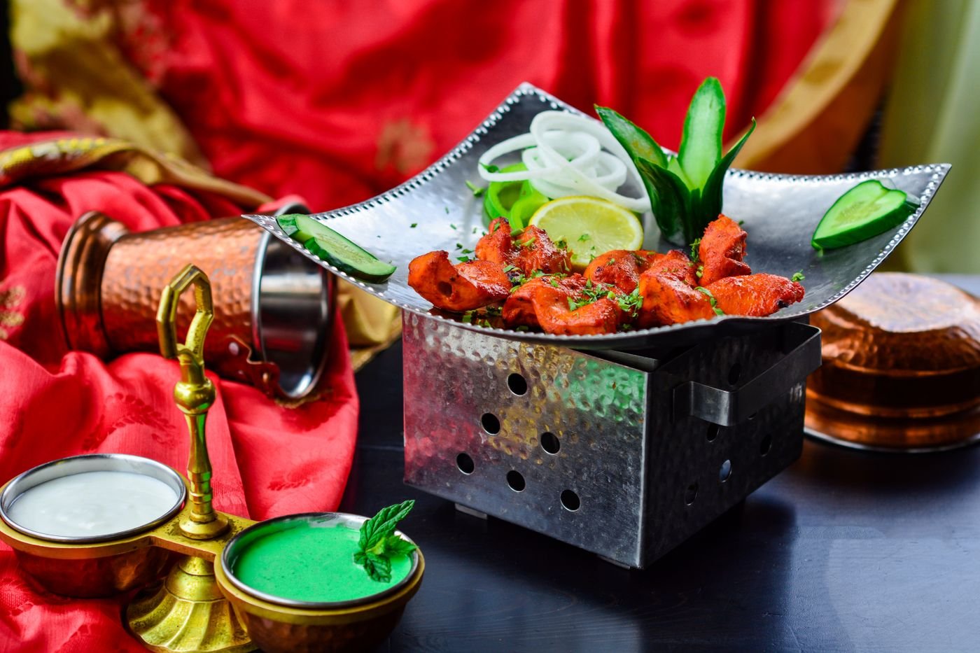 Chicken tikka served with fresh garnishes and sauce