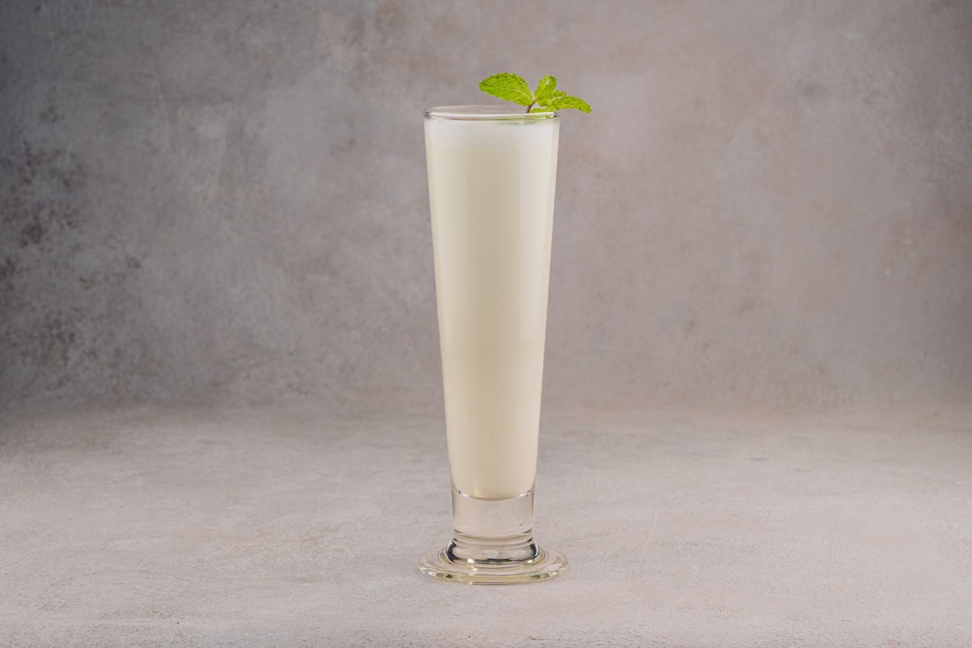 A chilled glass of lassi garnished with mint