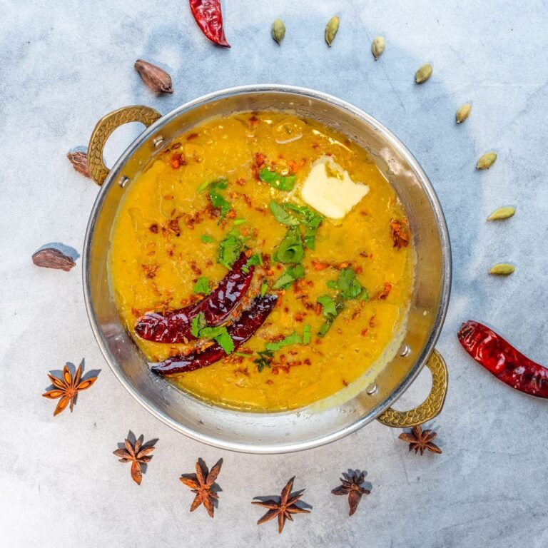 Yellow dal tadka served in a brass bowl