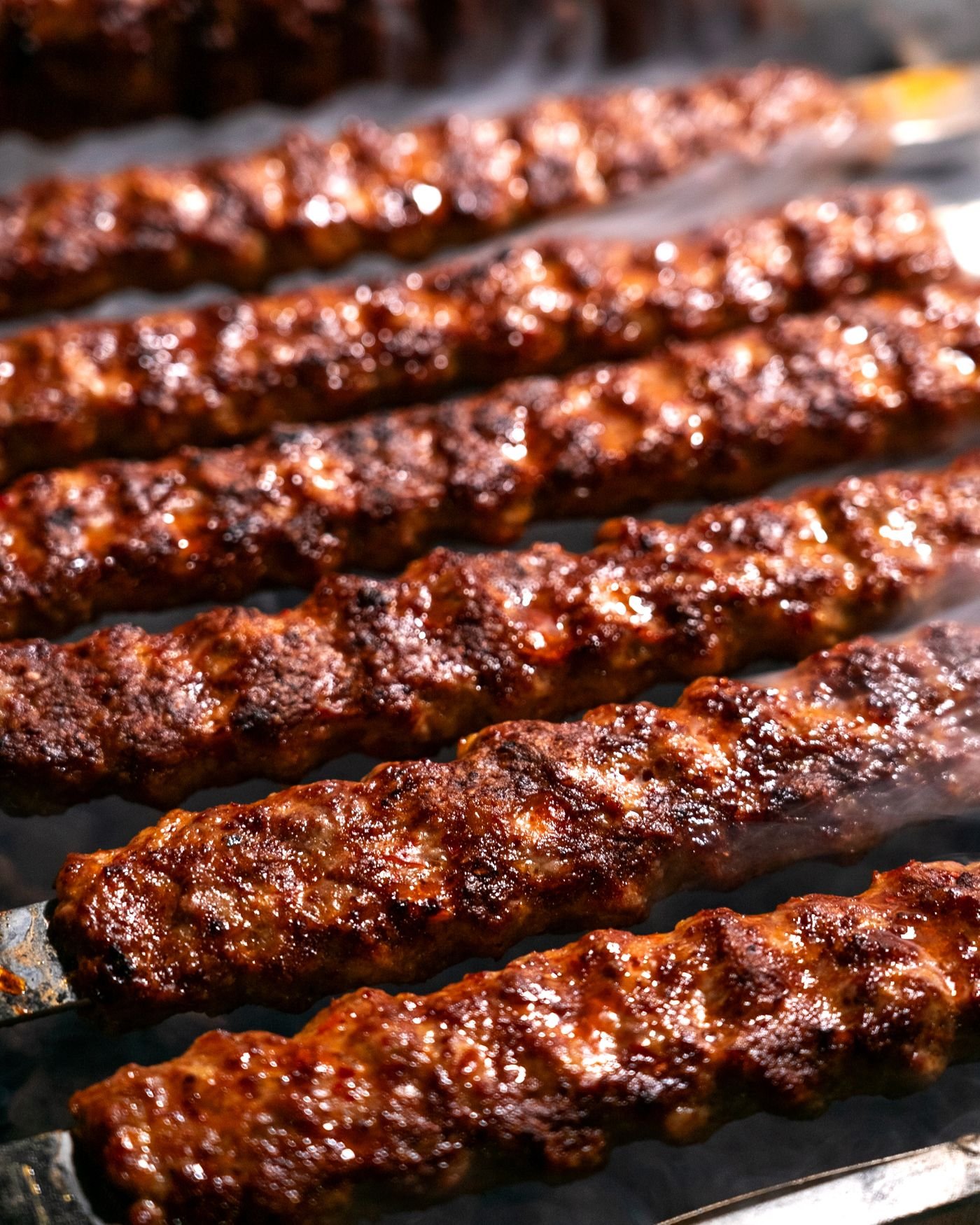 Grilled seekh kebabs on skewers, close-up