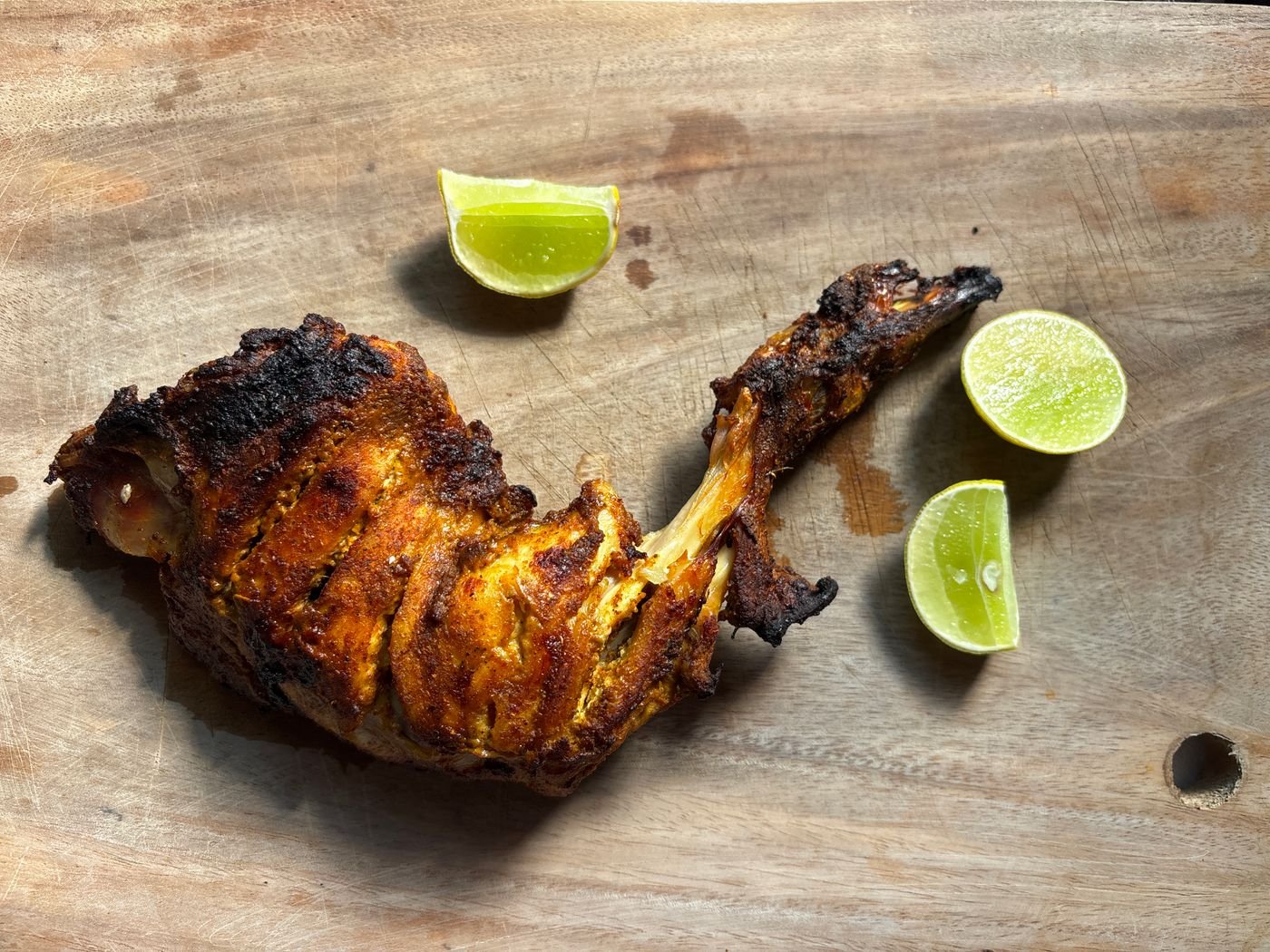 Tandoori chicken leg served with accompaniments
