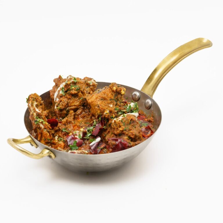 Creamy chicken curry served in a brass pan